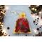 Gold organza bag of red potpourri from Irish Twins Potpourri with pine branches, lights, and star anise on light wood.